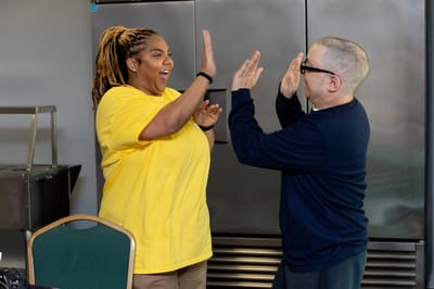 Two staff members engaging in an activity
