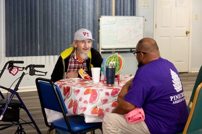 Two residents having a conversation in a common area