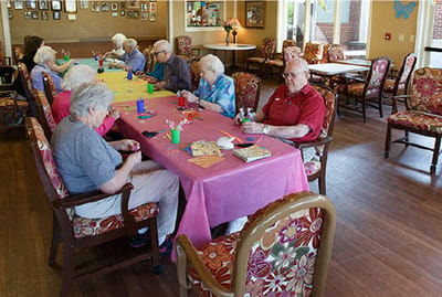Residents engaged in a craft activity in a common area