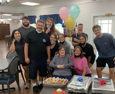 Residents and staff celebrating a birthday indoors