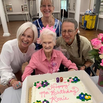 Residents celebrating a birthday with a cake