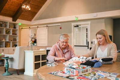 Resident and staff engaging in a creative activity
