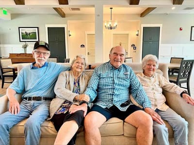 Four residents sitting together in a common area