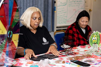 Residents and staff engaged in a bingo activity