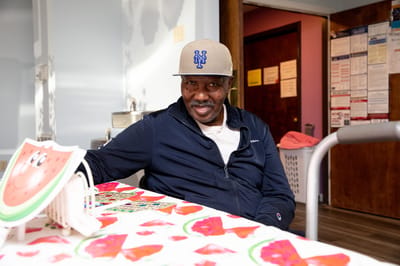 Resident smiling in a common area with colorful decor