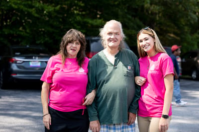 Residents and staff members posing outdoors