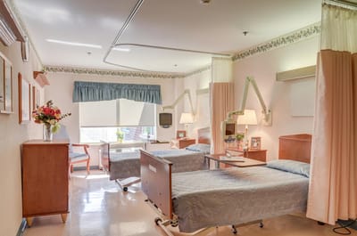 A cozy shared resident room featuring two beds