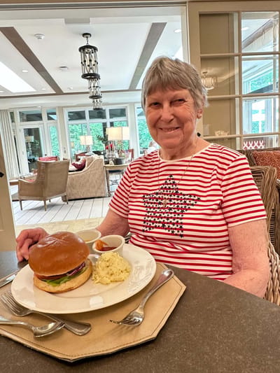 Resident enjoying a meal in the dining area