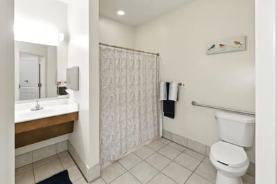 Clean private bathroom with shower and towels
