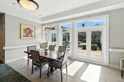 Bright dining area with large windows and a table