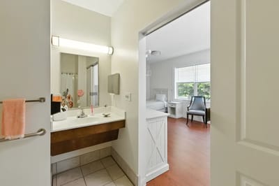 Bright interior view of a resident room and bathroom