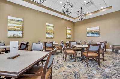 Bright dining room with tables and artwork