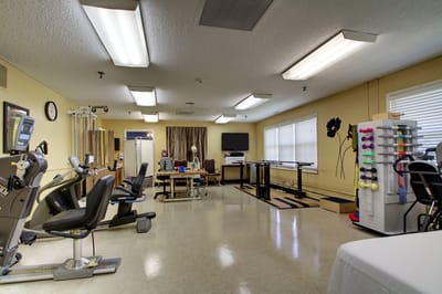 Rehabilitation gym with exercise equipment and therapy space