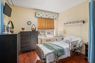 Private resident room with hospital bed and decor