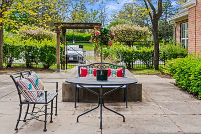 Outdoor seating area with greenery and patio