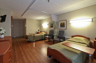 Spacious resident room with two beds and seating area