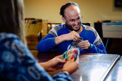 Resident enjoying a card game with fellow participant