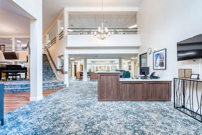 Bright interior common area with seating and a reception desk