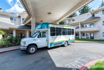 Facility transport van parked under an overhang