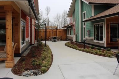 A pathway in a landscaped outdoor area of the facility