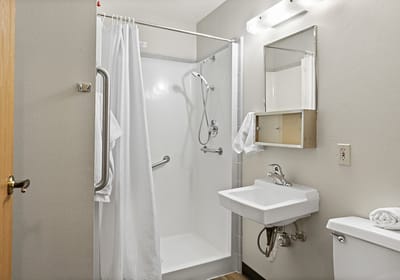 A clean, accessible bathroom with grab bars