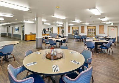 Dining area with tables and chairs for residents