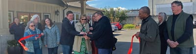 Ribbon-cutting ceremony at the facility entrance with attendees