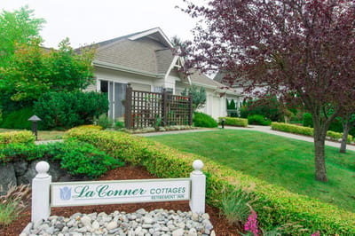 Exterior view of La Conner Retirement Inn with landscaped garden