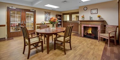 A common area with a fireplace and seating