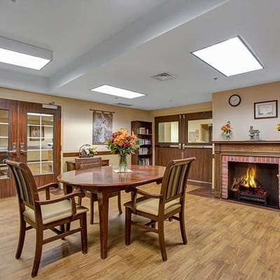 Bright common area with a table and fireplace