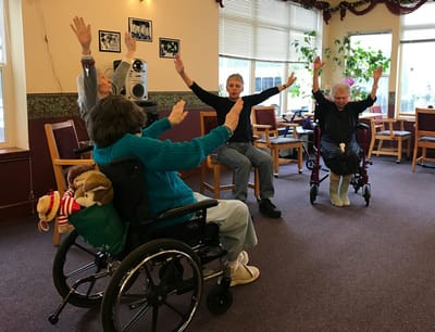 Residents participating in a seated exercise activity