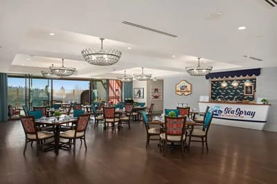 Bright dining area with colorful chairs and chandeliers