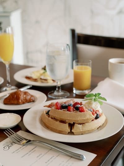 A beautifully arranged breakfast of waffles and fresh fruit
