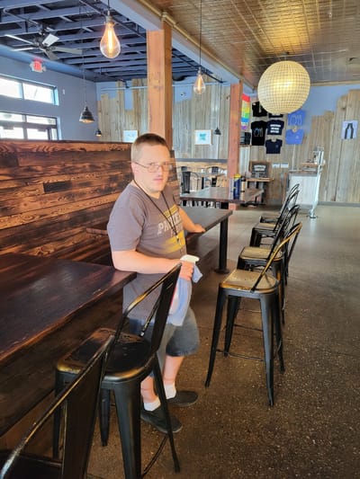A resident sitting at a table in a casual dining area