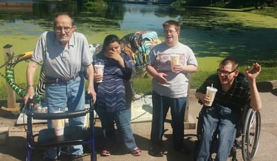 Residents enjoying time outdoors by a pond