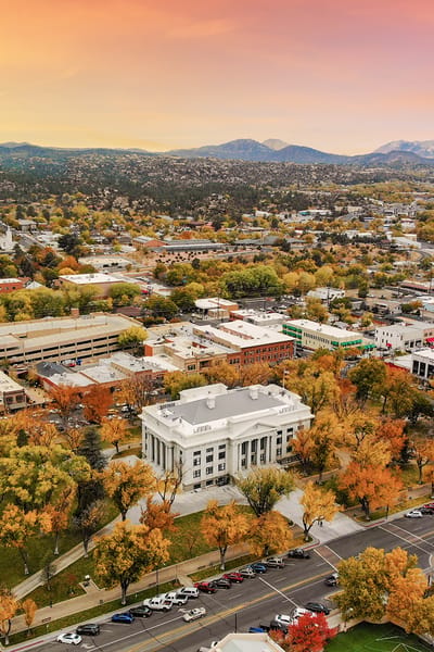 Aerial view of a building surrounded by trees in autumn