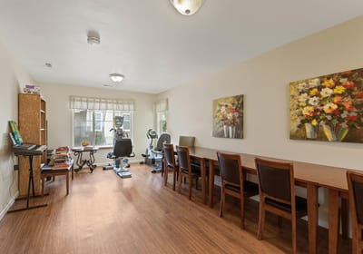 Bright common area with tables and artwork