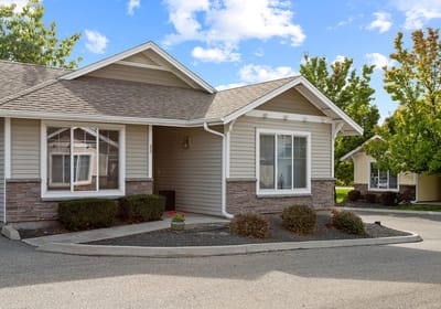 Exterior view of a senior living building with landscaping