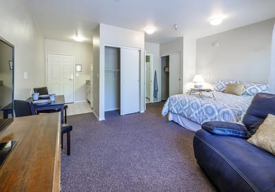 Cozy resident room with a bed and seating area
