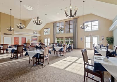 Bright dining room with tables set for meals