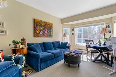 Cozy common area with blue couch and artwork