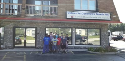 Group of people in front of a community growth facility