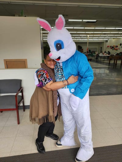 Resident greeting a person in a bunny costume.