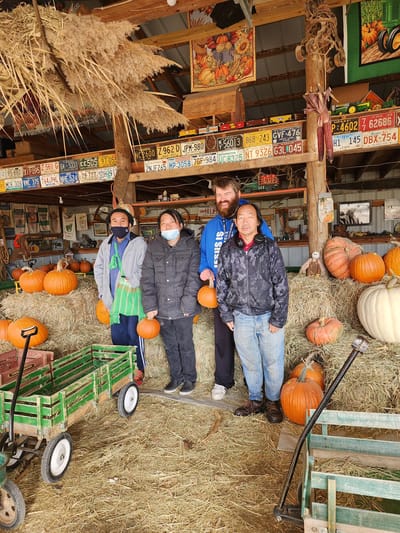Group of people in an interior space with pumpkins