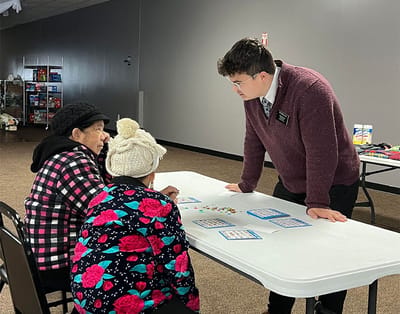 Residents engaging in a game with staff assistance