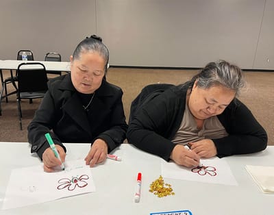 Residents engaged in a creative activity at a table