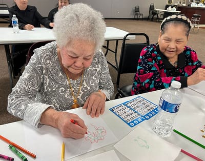 Residents engaging in an art activity at a table