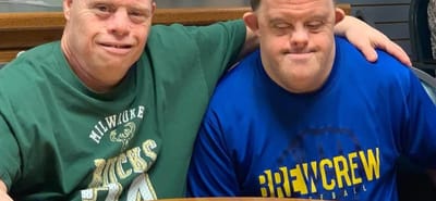 Two residents posing together at a table
