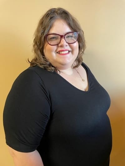 Staff member smiling in a friendly environment