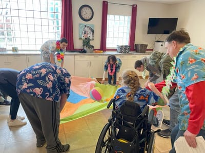 Residents and staff participating in an indoor activity